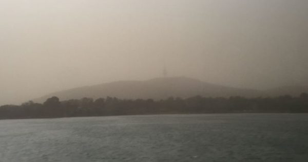 Dust settles in Canberra as storm passes to the coast
