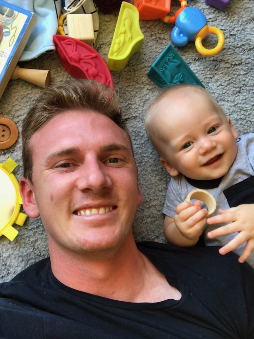 Kade relaxing with son, Tom. Photo: Supplied.