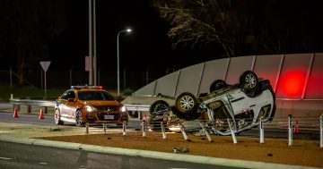 Firefighters free trapped woman from car after it rolls on Cotter Road