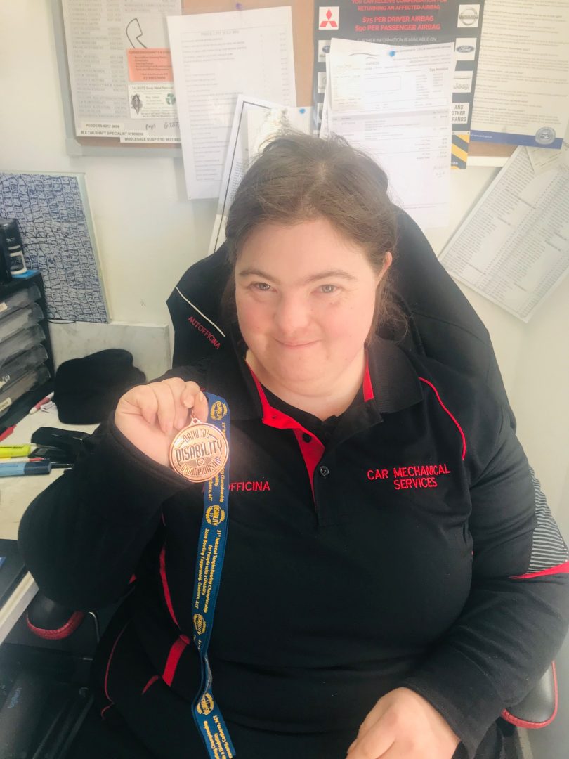 Naomi shows off her medal won for bowling