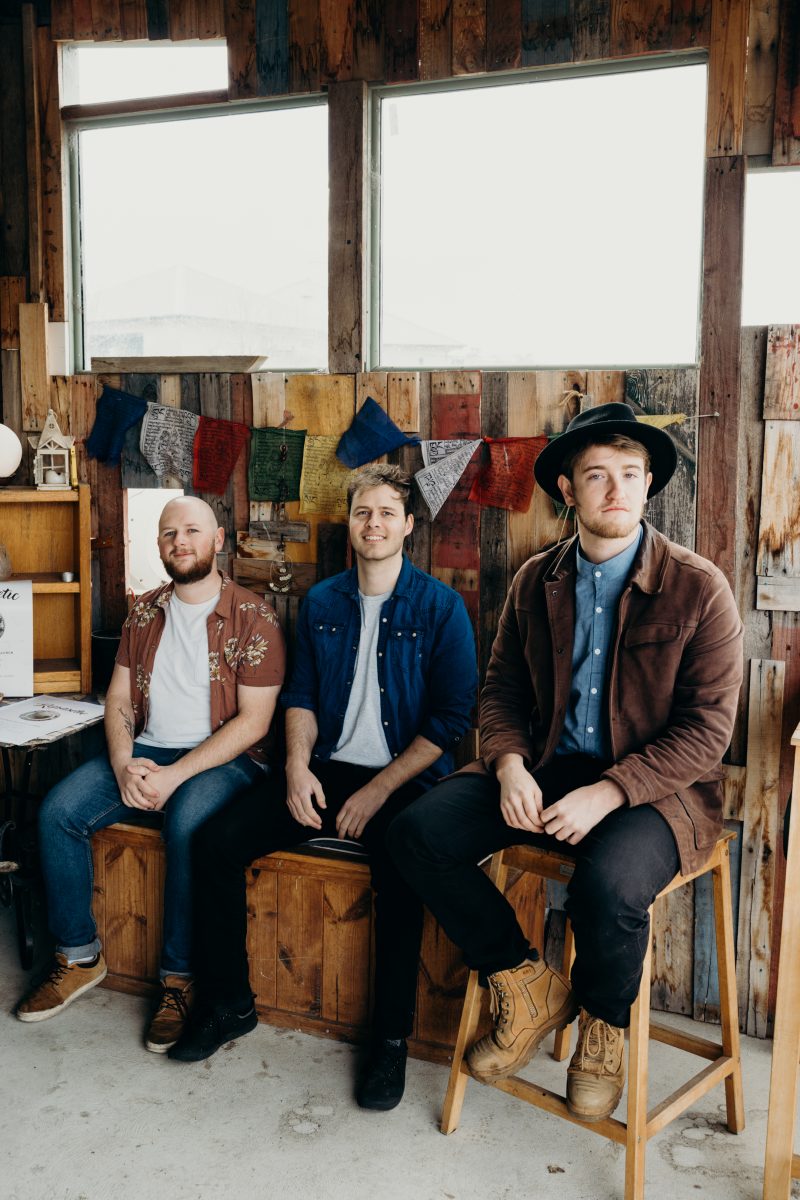 Local band Kopasetic, three men, sitting and smiling