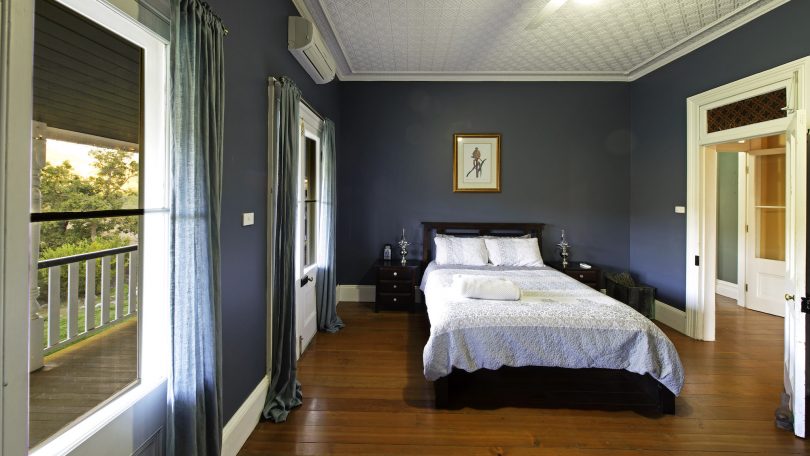 Each bedroom has its own ceiling pattern in pressed tin. Photo: Supplied