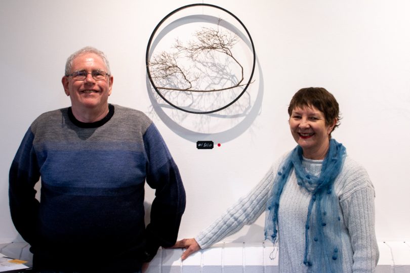 man and woman in front of artwork
