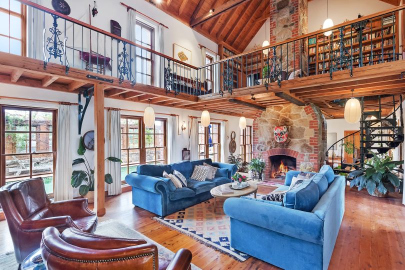 A galleria, a library level and warming stone fireplaces. Photo: Supplied