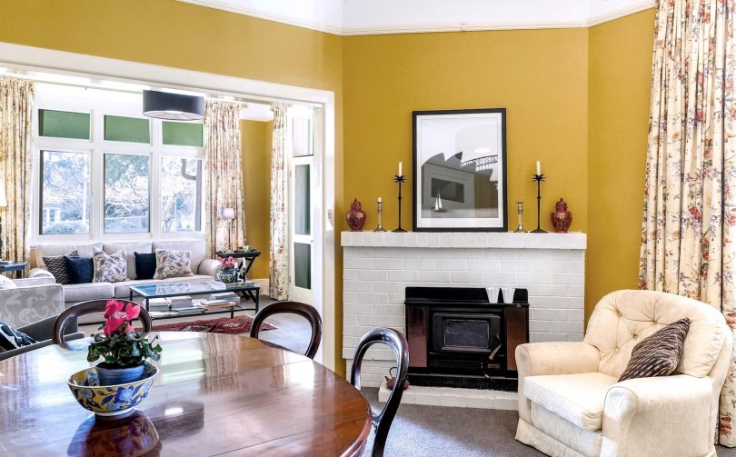 Light-filled formal sitting and dining rooms with pressed tin ceilings.