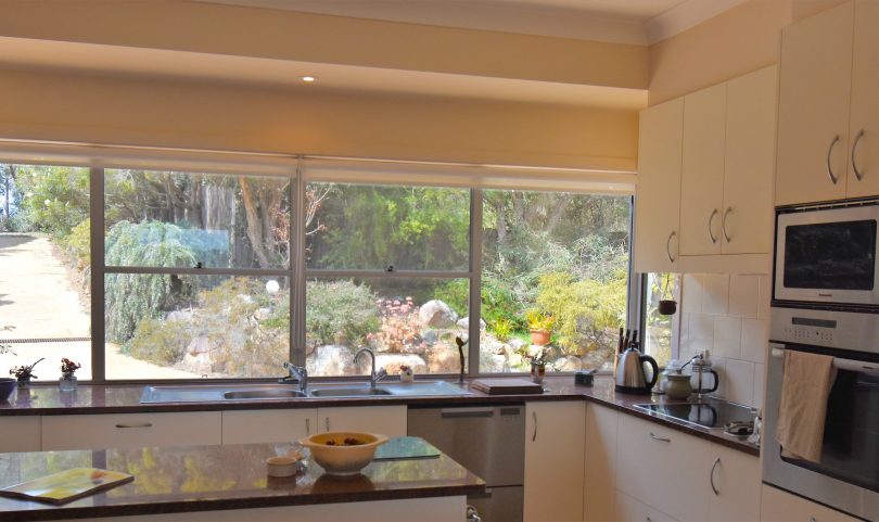 The kitchen gathers morning light and garden aspect. 