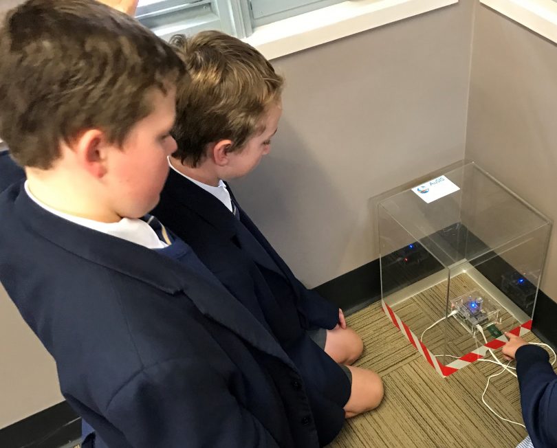 Student inspecting the seismometer at Snowy Mountain Grammar.