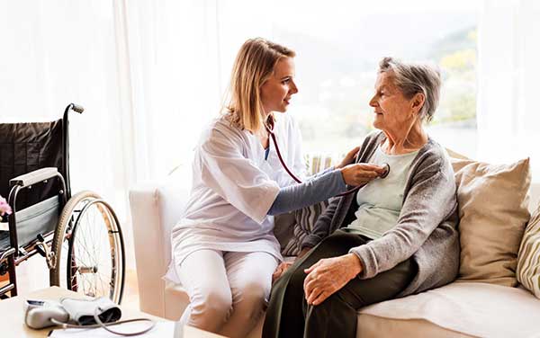 Image of a nurse looking after patient. 