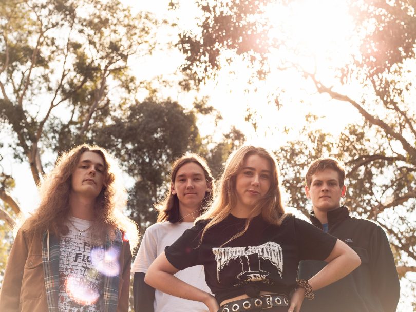 Photograph of Charlotte & The Harlots standing under trees on a sunny day