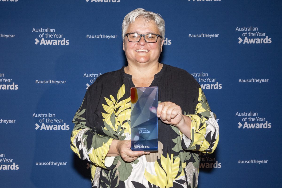 woman holding award