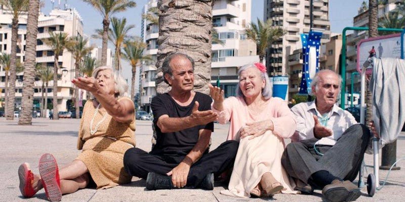 Still from Wanted shows four elderly people sitting under tree