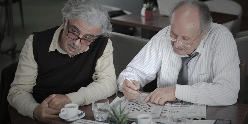 Still from Good Morning shows two men completing crossword