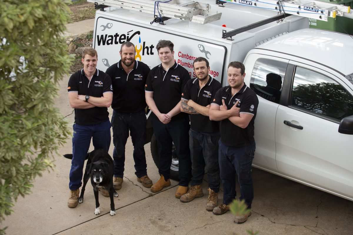 employees from Water Tight Canberra standing in front of a work van