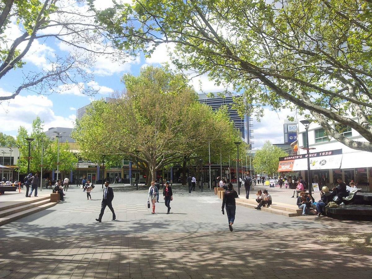 Streetscape of Garema Place in Canberra with people walking through it