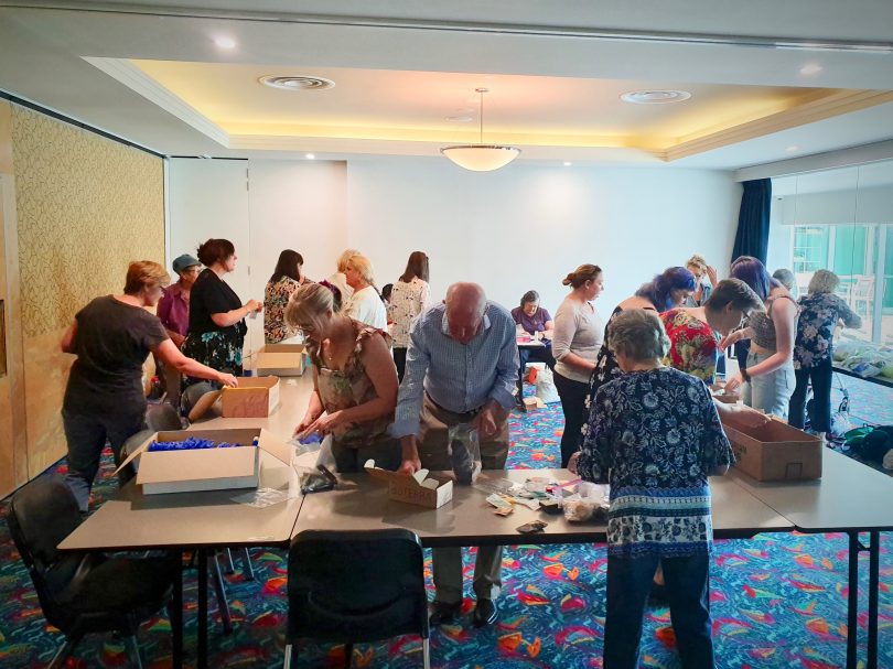 Volunteers pack Emergency Disaster Relief Care Kits