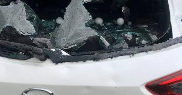 Windows smashed and records broken as wind and hail batters Canberra