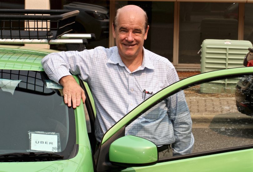 Uber driver John Burge leaning on car