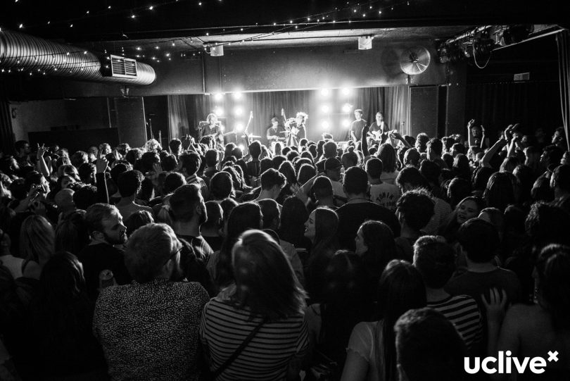 Photograph shows interior of concert at UC Hub