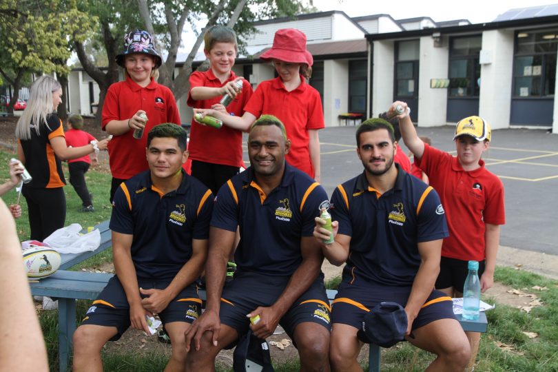 Brumbies players getting their hair sprayed