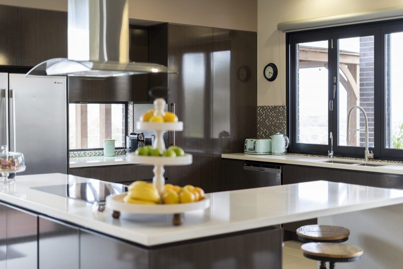 An entertainer's kitchen with bi-fold windows onto the deck. 