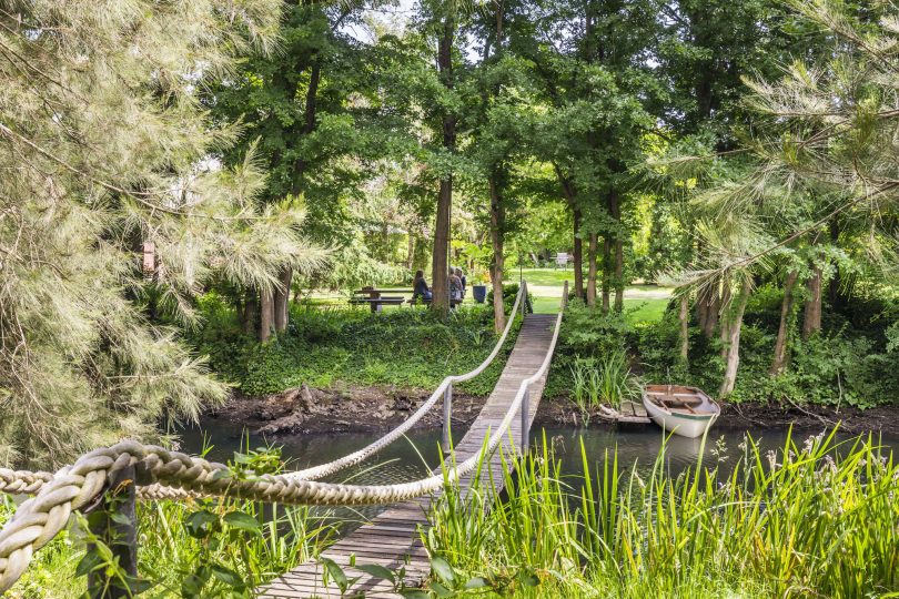 The owner/engineer of this property hand-built a suspension bridge over the creek.