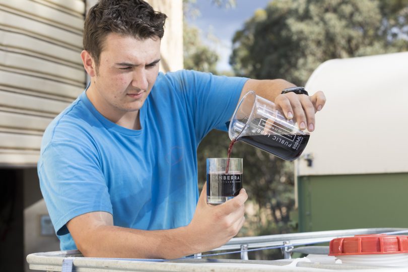 Thomas Darby prepares some merlot wine for distilling