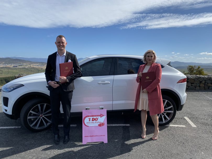 Marriage celebrants standing in front of a car in Canberra