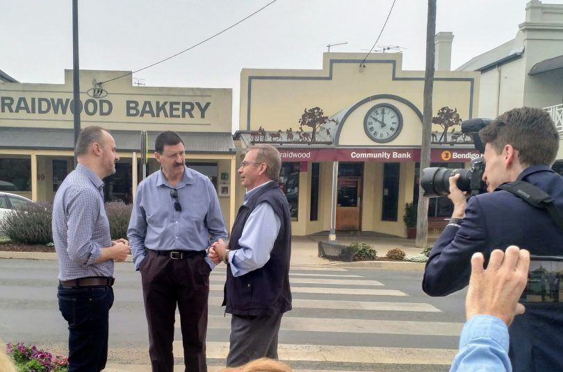 Andrew Barr, left, Dr Mike Kelly, centre, Tim Overall, right, in discussion on a Braidwood street.