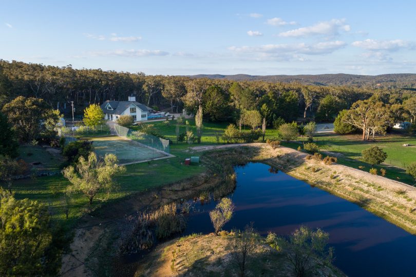 Aerial view of Scribbly Gums property, with dam in foreground and bushland in background.