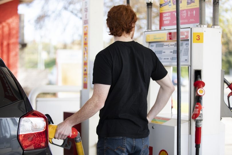 Man pumping fuel into car