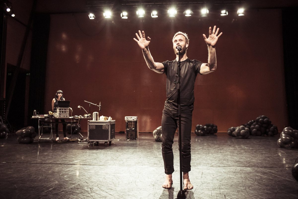 man wearing black on stage