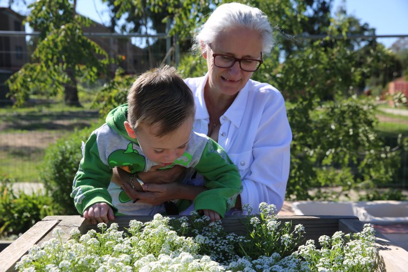 Trish and boy in garden