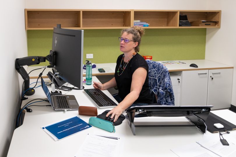 Dr Kerryn Coleman sitting at work desk.