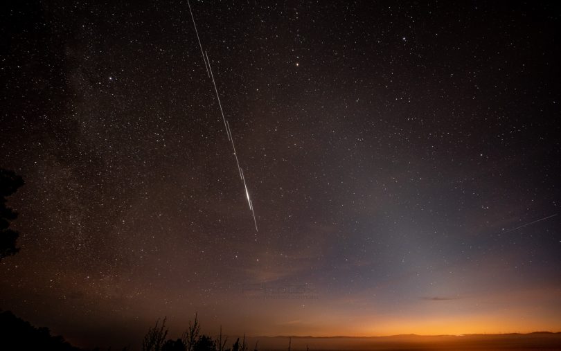 The Starlink satellite with a meteor on the right over Canberra.