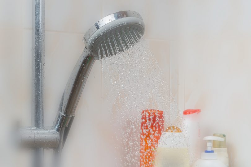 Water running from bathroom shower head.