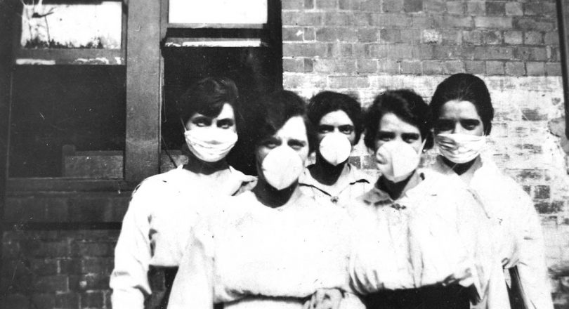 Archival image of women wearing surgical masks in 1919 during Spanish flu.