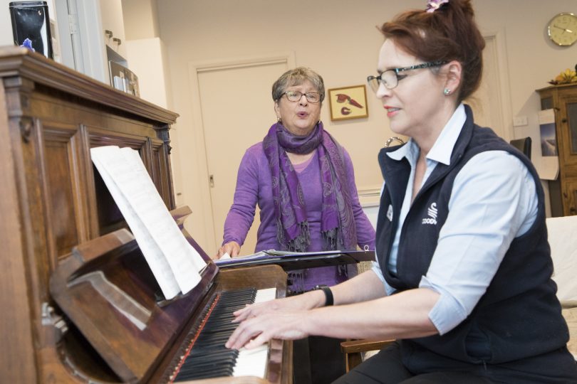 Catherine playing piano while Yvonne sings.