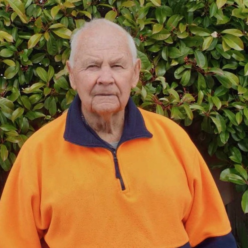 Brian Mills standing in garden.