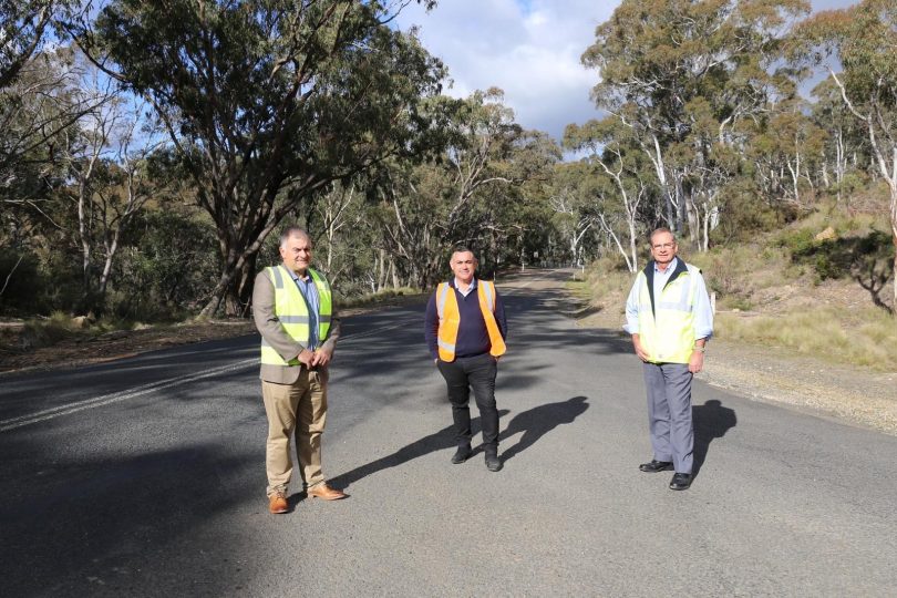 Councillor Trevor Hicks, Member for Monaro John Barilaro and Queanbeyan-Palerang mayor Tim Overall standing on Captains Flat road