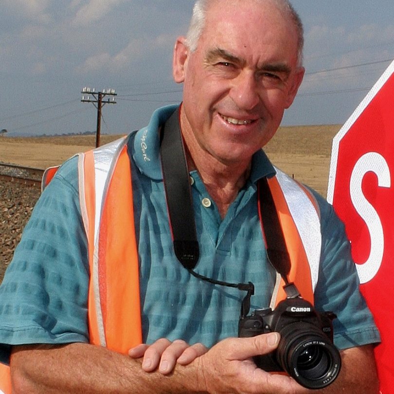 Goulburn photographer Leon Oberg leaning against stop sign.