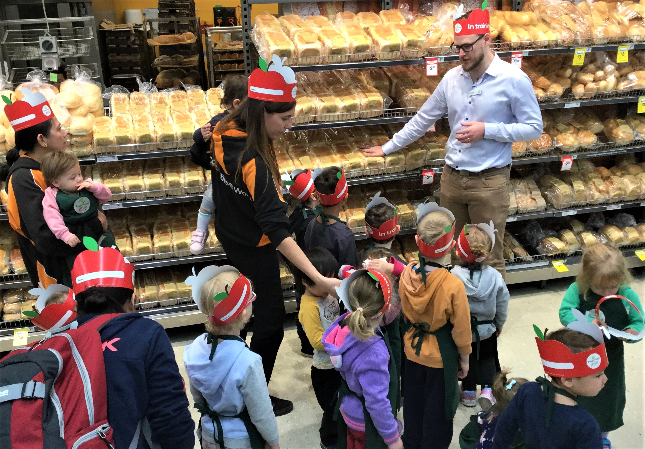 Children on a behind-the-scenes tour of Woolworths.