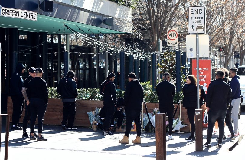 Mourners gather outside of Kokomos in Civic on Tuesday morning