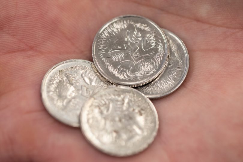 Five-cent pieces in a hand