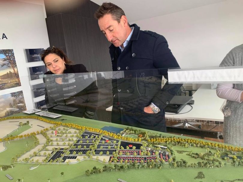 Village Building Company CEO Travis Doherty inspecting the model of South Jerrabomberra estate