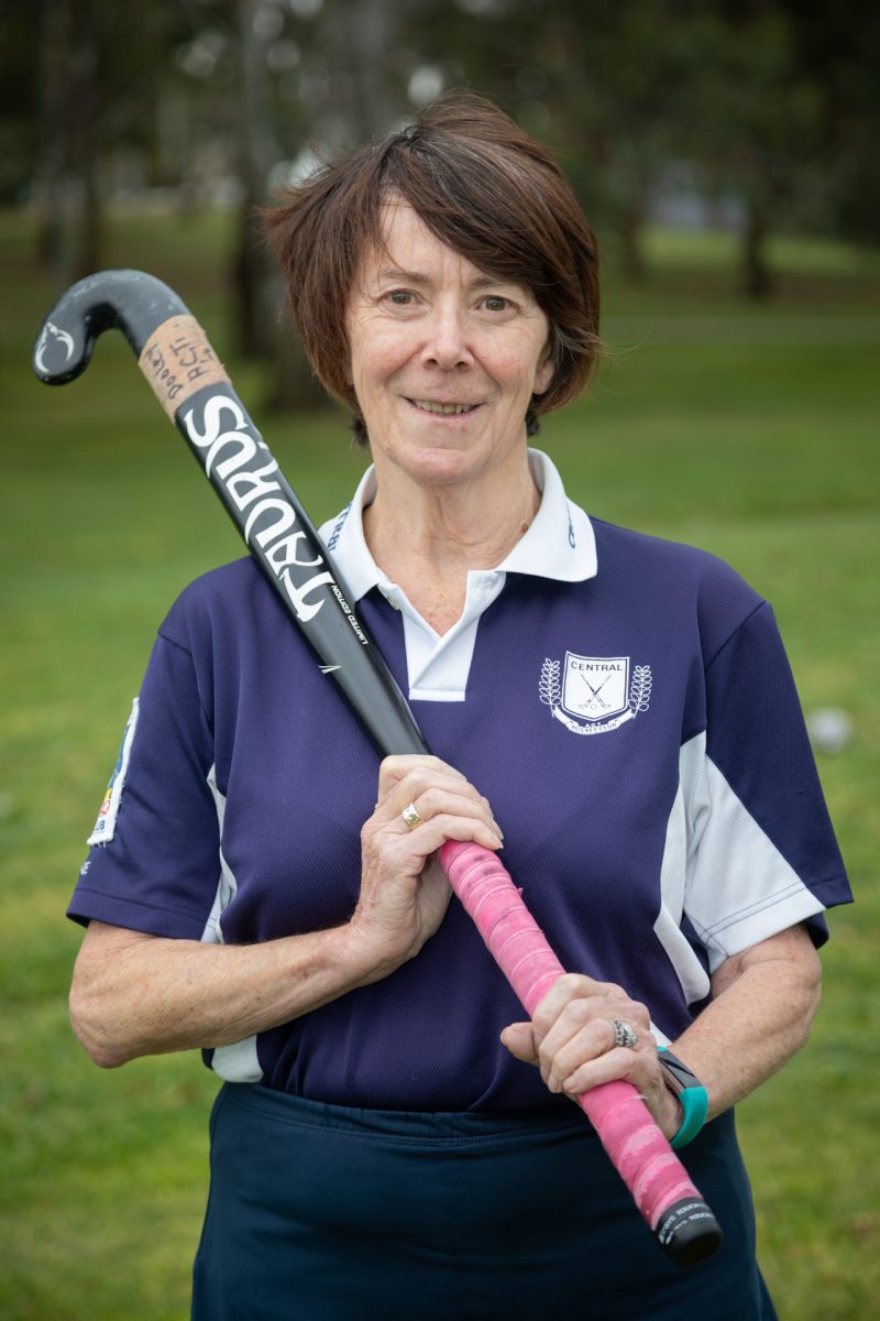 Catherine Dooley holding hockey stick.