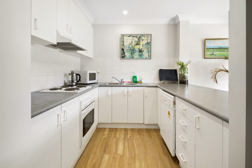 The kitchen has all modern conveniences, and is connected with the living room.