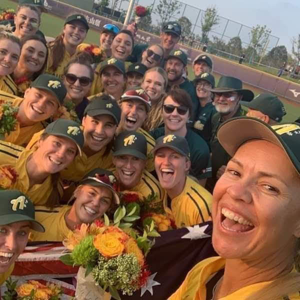 Clare Warwick posing with Australian softball team