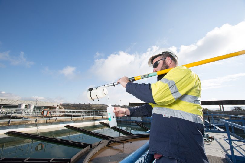 Icon Water worker testing water quality.