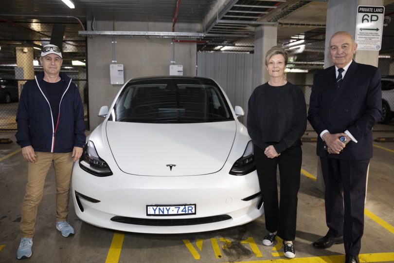 Robert Azzopardi, Jo Elkington and Peter Zakharoff standing next to electric vehicle.