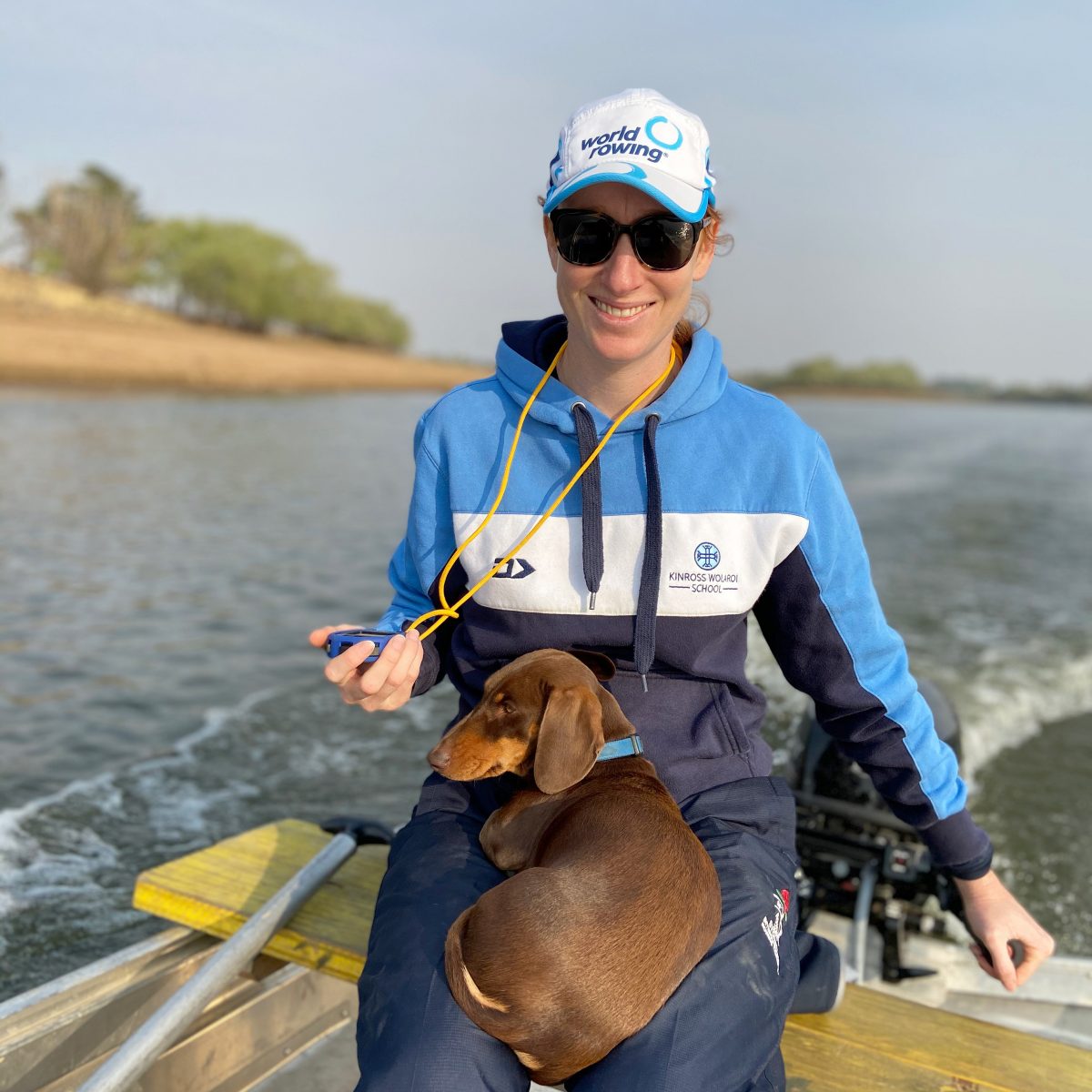 woman in boat with a dog on her lap